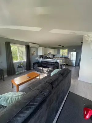 a living room with a couch and a table at Sunrise Mountain view Skidegate House in Skidegate