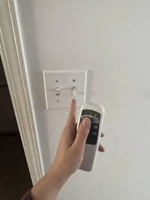 a person holding a remote control in a refrigerator at Cozy Home in Camrose