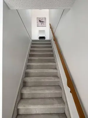 a staircase in a building with a stair case at Cozy Home in Camrose