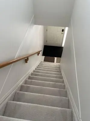 a stairway with a set of stairs in a building at Cozy Home in Camrose