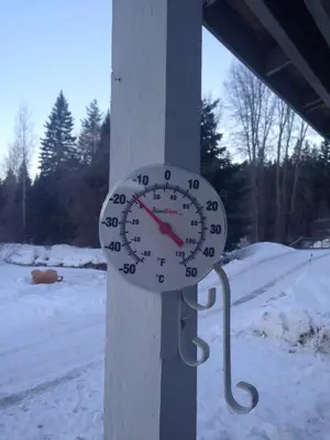 a clock is attached to a pole in the snow at Witt's End Ranch Private Get Away in Princeton