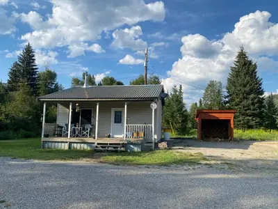 a small house with a porch and a garage at Witt's End Ranch Private Get Away in Princeton