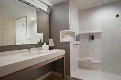 a bathroom with a sink and a shower at Courtyard by Marriott Nanaimo in Nanaimo