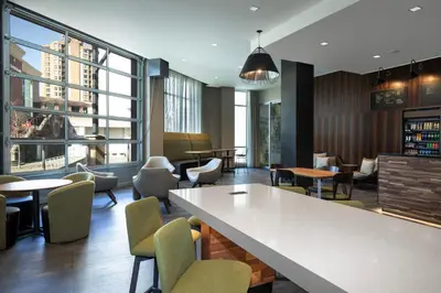 a restaurant with tables and chairs and a large window at Courtyard by Marriott Nanaimo in Nanaimo