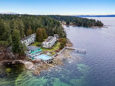 an aerial view of a house on an island in the water at Sunrise Cove Apt at Inn of The Sea in Ladysmith