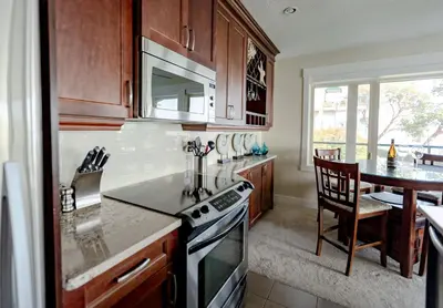 a kitchen with a stove and a counter top at Sunrise Cove Apt at Inn of The Sea in Ladysmith