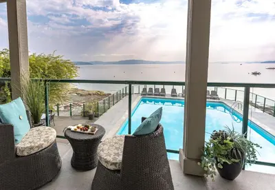 a view from the balcony of a hotel with a swimming pool at Sunrise Cove Apt at Inn of The Sea in Ladysmith