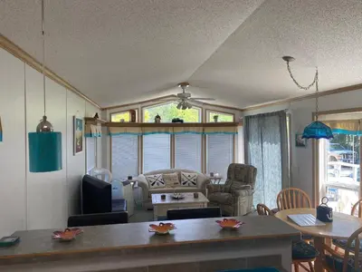 a living room with a table and a couch at Beaver Lake Resort Site #36 in Lake Cowichan
