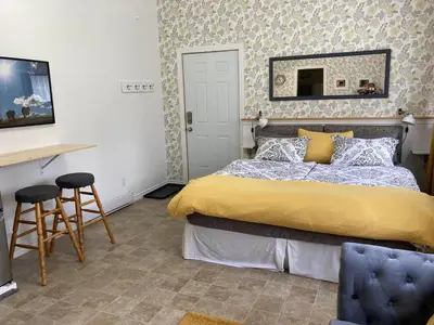 a bedroom with a bed and a table and a mirror at Battle Creek Ranch, Wells Gray Park in Clearwater