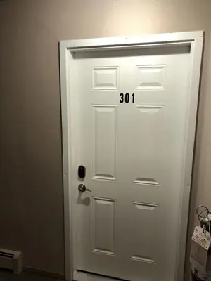 a white door with the number on it at unit #301 Mountain view 2BR in Canmore Down town in Canmore