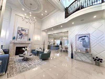 a large living room with a fireplace and a chandelier at Vancouver Shangrila House in Richmond
