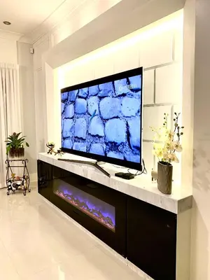 a large flat screen tv on a stand in a living room at Vancouver Shangrila House in Richmond