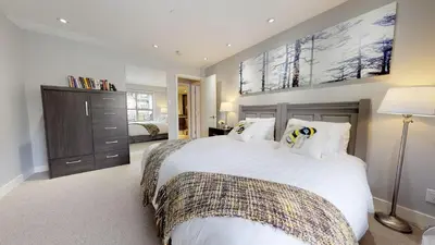 a bedroom with a large white bed with white pillows at 260 The Aspens - Ski In Ski Out in Whistler