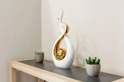 a gold and white vase on a table with two plants at Modern & Stylish 1-Bedroom Unit in Edmonton