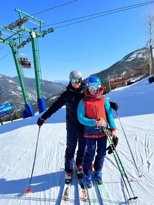two people on skis on a ski lift at Perfect Ski or Bike in-out Hot Tub Pool in Panorama