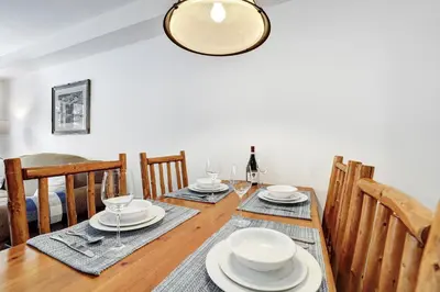 a dining room with a wooden table and chairs at Perfect Ski or Bike in-out Hot Tub Pool in Panorama