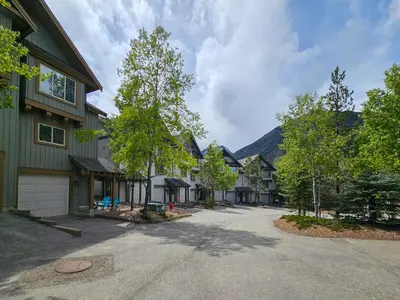 a row of houses with trees and a driveway at Hearthstone Townhomes by StayIn in Panorama