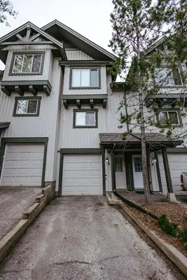 a house with two garage doors and a driveway at Hearthstone Townhomes by StayIn in Panorama