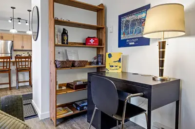 a desk with a lamp and a chair in a room at Mountain Retreat - Modern and Bright with Panorama Views 2 bedrooms, 4 beds, heated all-year outdoor pool, hottub, balcony, Banff Park Pass in Canmore