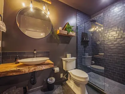 a bathroom with a sink and a toilet and a shower at Winter's Hideaway Suite in Ucluelet