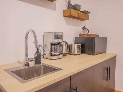 a kitchen with a sink and appliances on a counter at Winter's Hideaway Suite in Ucluelet