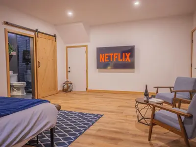 a bedroom with a netflix sign on the wall at Winter's Hideaway Suite in Ucluelet
