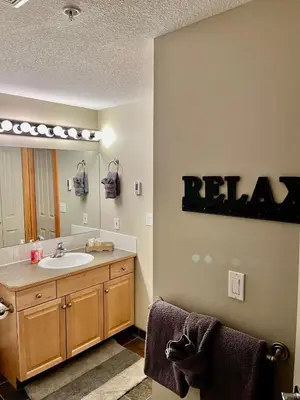 a bathroom with a sink and a mirror at Wanna get away next Summer and Fall at the Crossing in Canmore