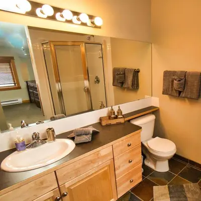 a bathroom with a sink and a toilet and a mirror at Wanna get away next Summer and Fall at the Crossing in Canmore