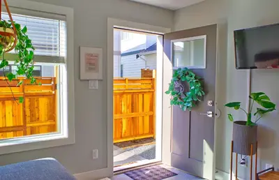 a door leading to a porch with a wooden fence at Zen Retreat Langford in Victoria