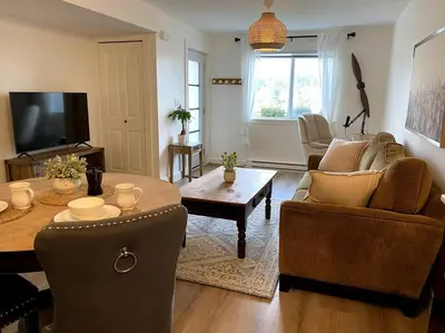 a living room with a table and a couch at Cozy Lakeview Suite in Victoria