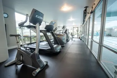 a row of cardio machines in a gym at Heart of Downtown King Suite/Parkng/Pool/Gym/Sauna in Vancouver