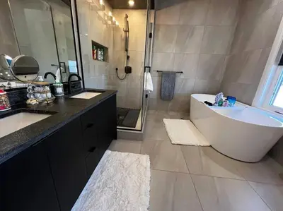 a bathroom with a tub and a sink and a shower at Stunning 3BR Luxury Home N/Edm*2 king beds* in Edmonton