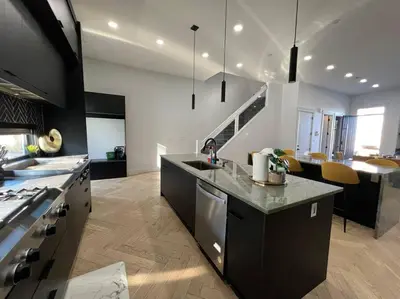 a kitchen with black and white appliances in a room at Stunning 3BR Luxury Home N/Edm*2 king beds* in Edmonton