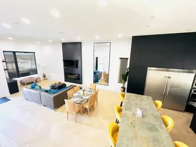 a living room with a table and a couch at Stunning 3BR Luxury Home N/Edm*2 king beds* in Edmonton