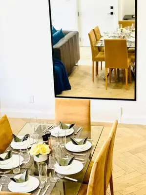 a dining room table with plates and glasses on it at Stunning 3BR Luxury Home N/Edm*2 king beds* in Edmonton