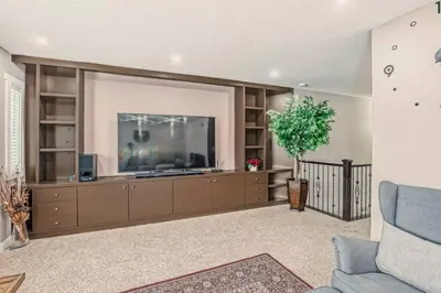 a living room with a large flat screen tv at Luxury 4 Bedroom Cozy Home close to YYC, Shops, DT, Stampede, Mountains and many amenities in Panorama Hills NW Calgary in Calgary