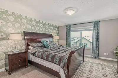 a bedroom with a bed and a window at Luxury 4 Bedroom Cozy Home close to YYC, Shops, DT, Stampede, Mountains and many amenities in Panorama Hills NW Calgary in Calgary