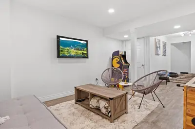a living room with a couch and chairs and a table at Cozy Home - 9mins to WEM -Foosball -Vintage arcade - Air conditioning in Edmonton