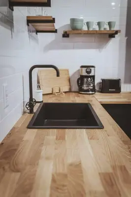 a kitchen with a sink and a wooden counter top at NYC Loft Inspired •12 mins to WEM •Vintage arcade in Edmonton