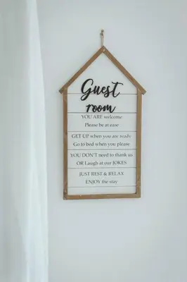 a guest room sign hanging on a white wall at NYC Loft Inspired •12 mins to WEM •Vintage arcade in Edmonton