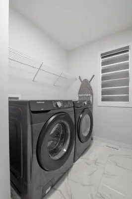 a washing machine in the corner of a room at Luxury-4bed with AC-86