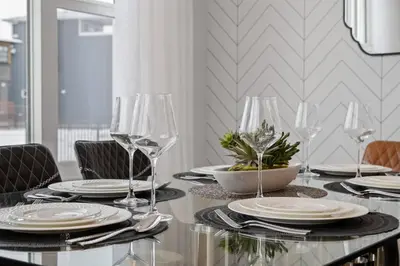 a table with plates and wine glasses on it at Luxury-4bed with AC-86