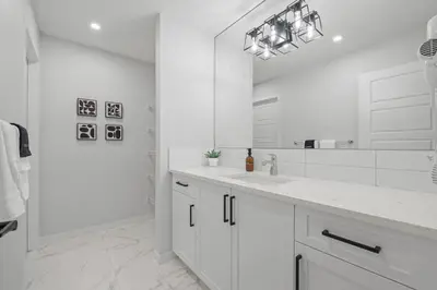 a white bathroom with a sink and a mirror at Luxury-4bed with AC-86