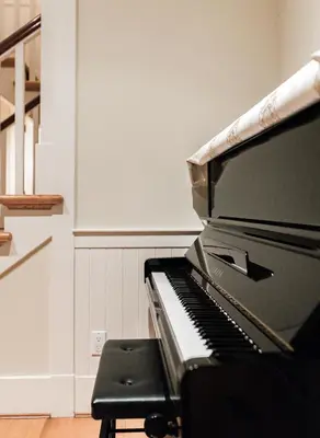 a piano sitting in a room with a stool at Vancouver Golf Villa - Private Oasis in Vancouver
