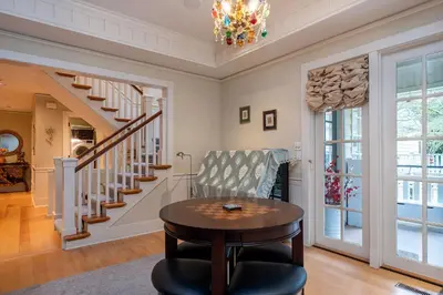 a living room with a table and a staircase at Vancouver Golf Villa - Private Oasis in Vancouver