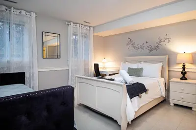 a bedroom with a white bed and a desk at Vancouver Golf Villa - Private Oasis in Vancouver