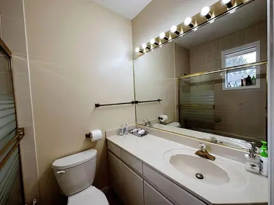 a bathroom with a sink and a toilet and a mirror at Super Cosy 8Bed & 6Bath in Vancouver heart near to airport and DownTown in Vancouver