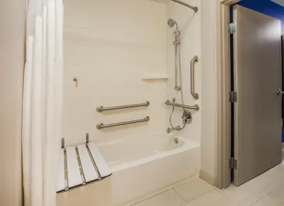 a bathroom with a tub and a shower with a shower curtain at Holiday Inn Express & Suites Courtenay - Comox by IHG in Courtenay