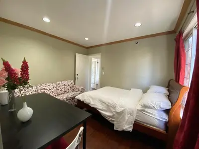 a living room with a bed and a couch at Cozy Dunbar 3 Beds Home w/ Views in Vancouver