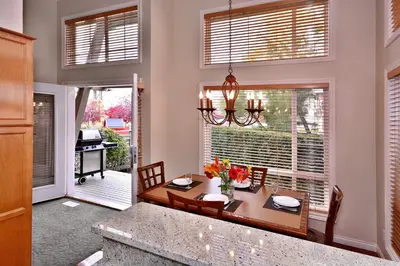 a dining room with a table and a window at Villas at Eldorado Resort in Kelowna